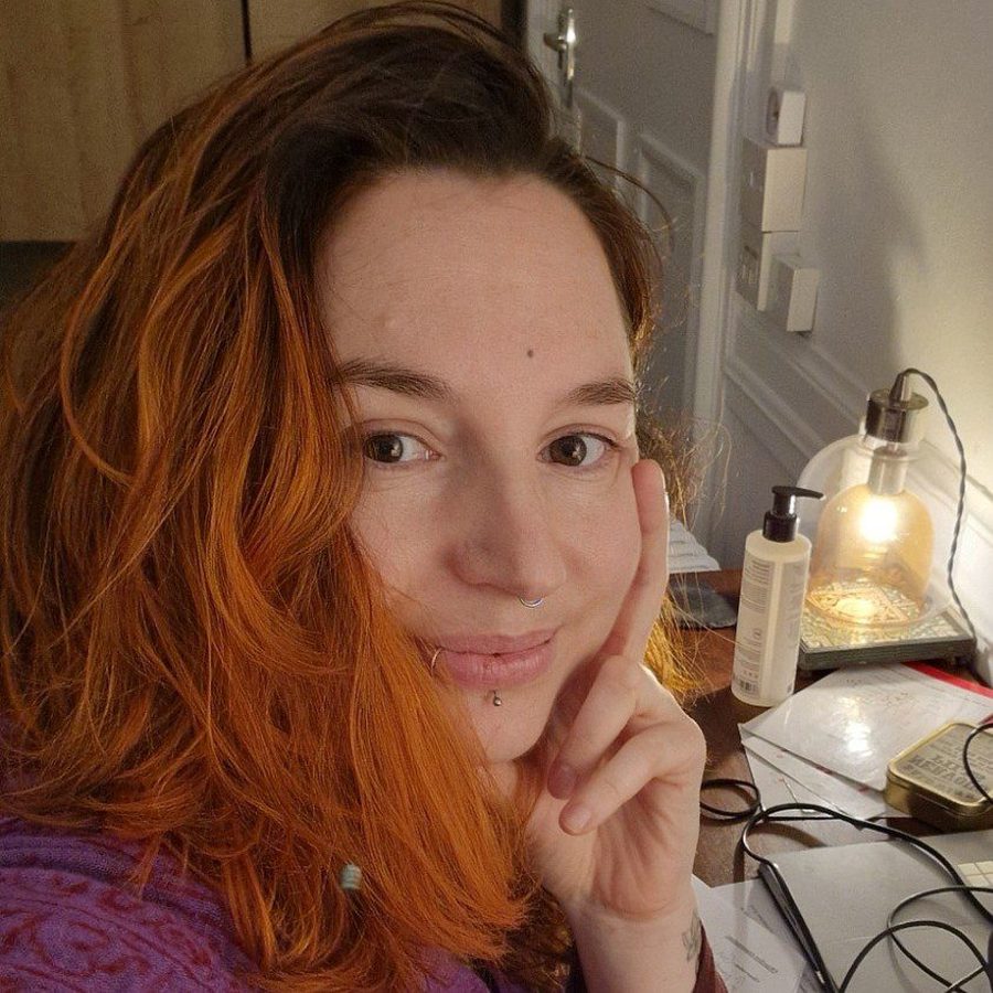 Elodie Gauthier, smiling, at her desk in warm lamplight